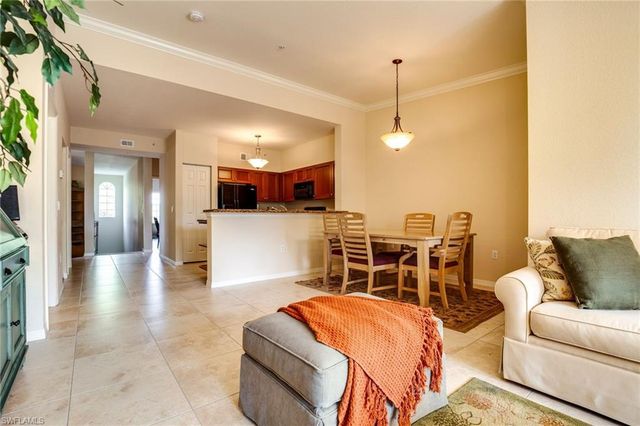 a living room with stainless steel appliances kitchen island granite countertop furniture and a kitchen view