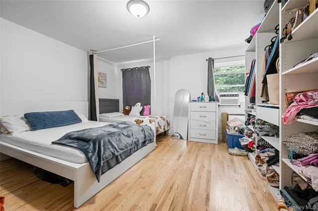 a bedroom with a bed and a wooden floor