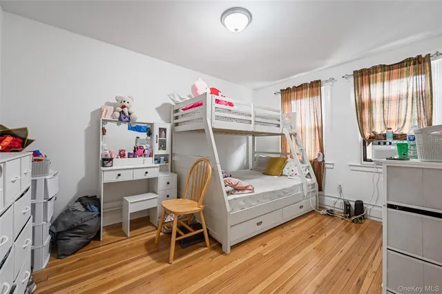 a bedroom with furniture and a wooden floor