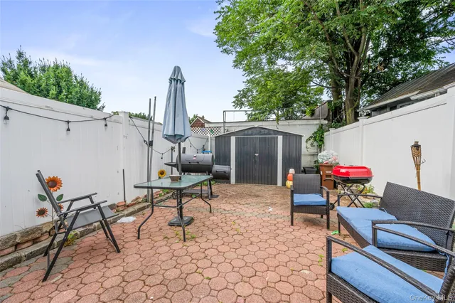 a view of a patio with a dining table and chairs