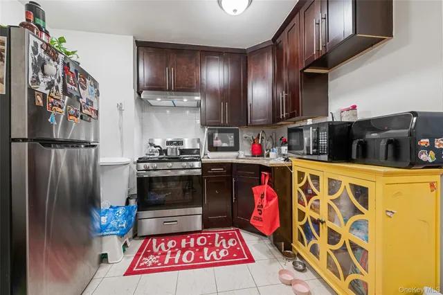 a kitchen with stainless steel appliances granite countertop a refrigerator and a stove