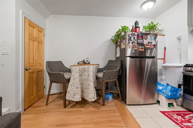 a view of a dining room with furniture and a potted plant