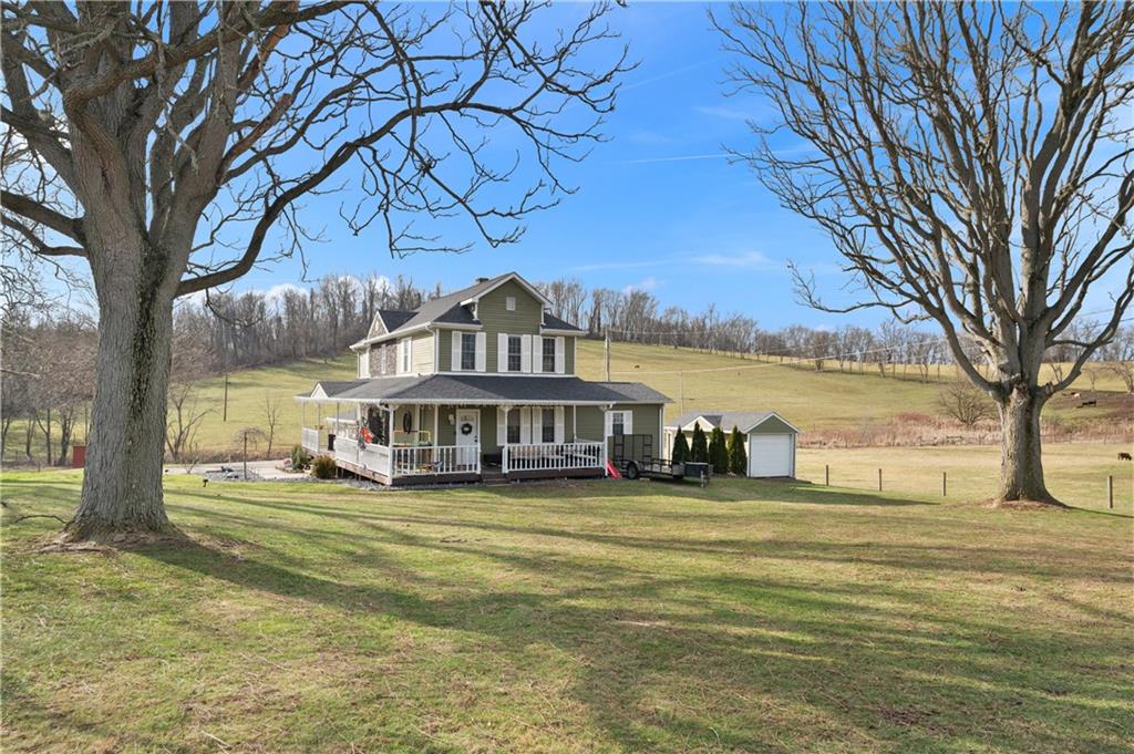 34 Cherry Farm Lane Dunbar, PA 15431 - Photo 4 of 22 a view of a house next to a big yard and large trees