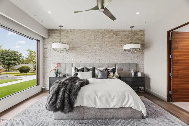 a bed room with two bed and a large window