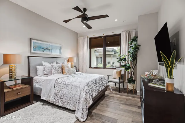 a bedroom with a large bed and a flat tv screen