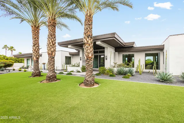 a front view of house with yard and green space