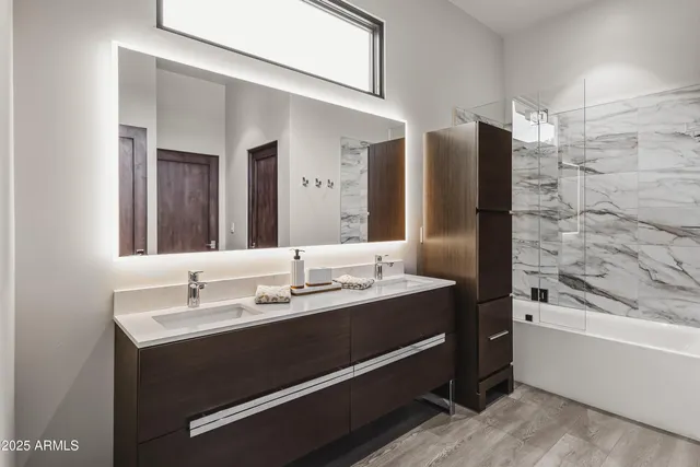 a bathroom with a tub sink and mirror
