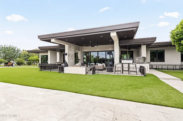a view of a patio with table and chairs potted plants and large tree