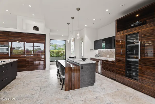 a kitchen with stainless steel appliances kitchen island granite countertop a refrigerator and a stove