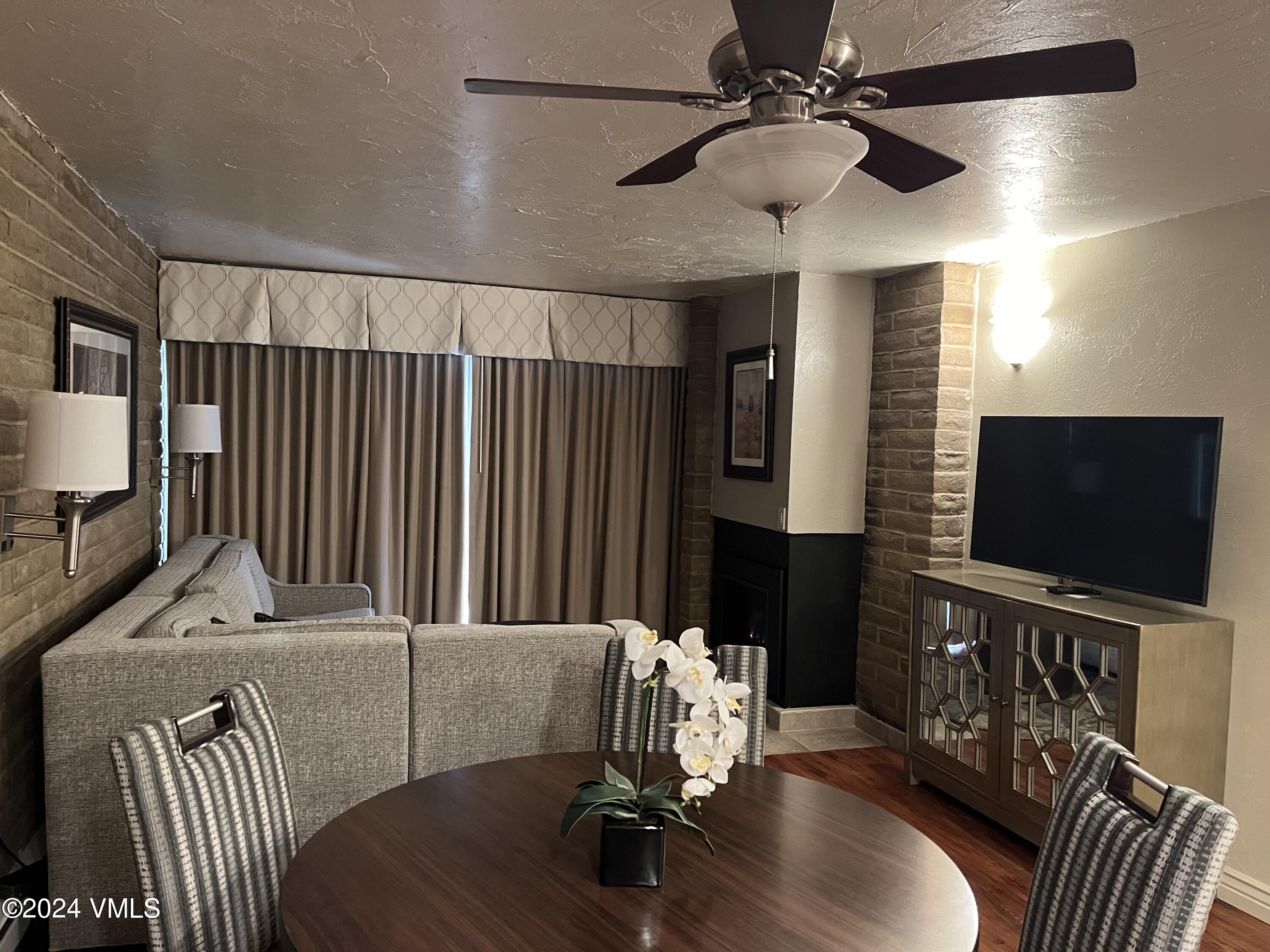 1020 Vail View Drive, Unit 131138 Vail, CO 81657 - Photo 2 of 19 a living room with furniture and a flat screen tv