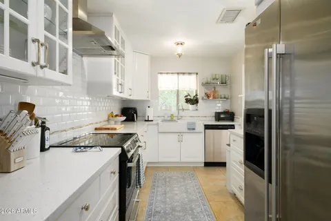 a kitchen with cabinets and stainless steel appliances