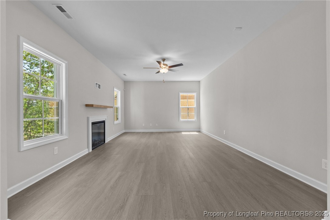509 Watauga Lane Aberdeen, NC 28315 - Photo 12 of 29 wooden floor in an empty room with a fireplace