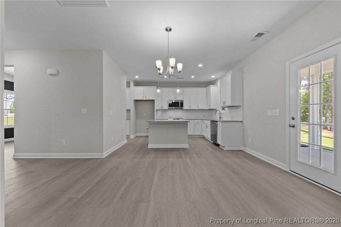 509 Watauga Lane Aberdeen, NC 28315 - Photo 15 of 29 a view of a kitchen with a sink wooden cabinets and window