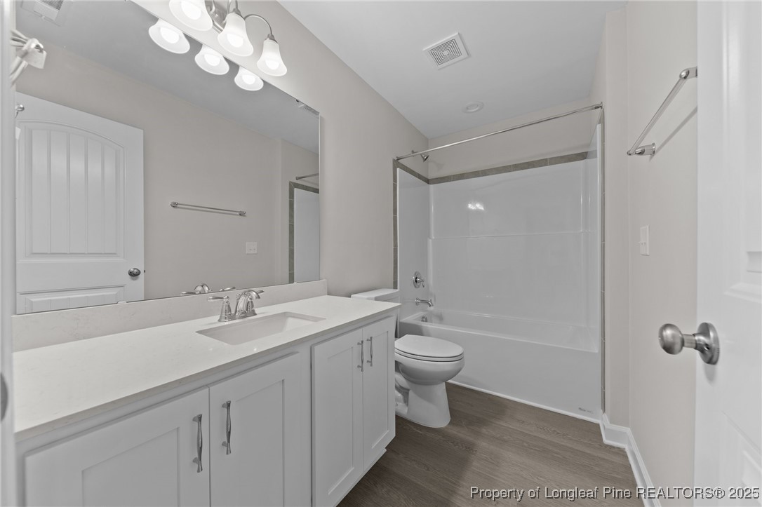 509 Watauga Lane Aberdeen, NC 28315 - Photo 22 of 29 a bathroom with a double vanity sink a toilet and shower