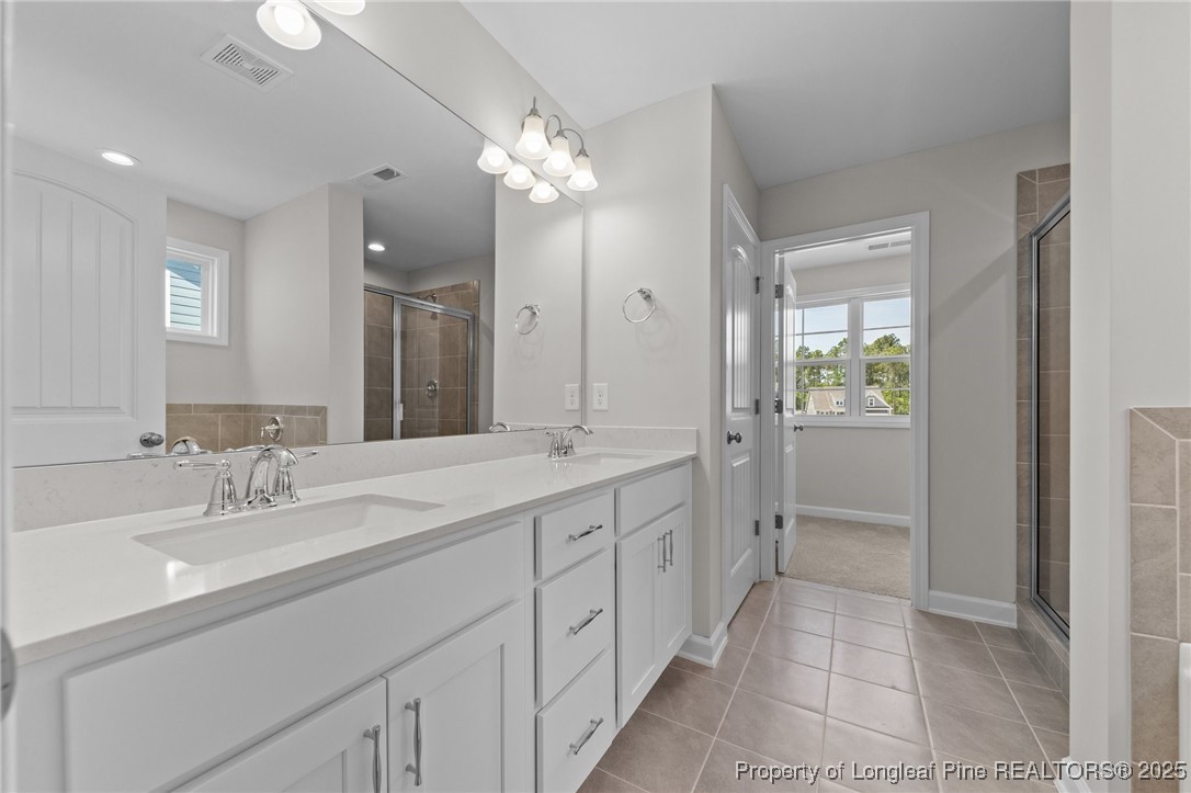 509 Watauga Lane Aberdeen, NC 28315 - Photo 25 of 29 a spacious bathroom with a granite countertop sink a toilet and a mirror