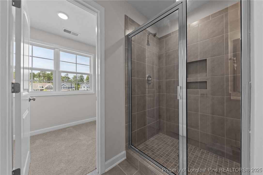509 Watauga Lane Aberdeen, NC 28315 - Photo 26 of 29 a bathroom with a glass shower door