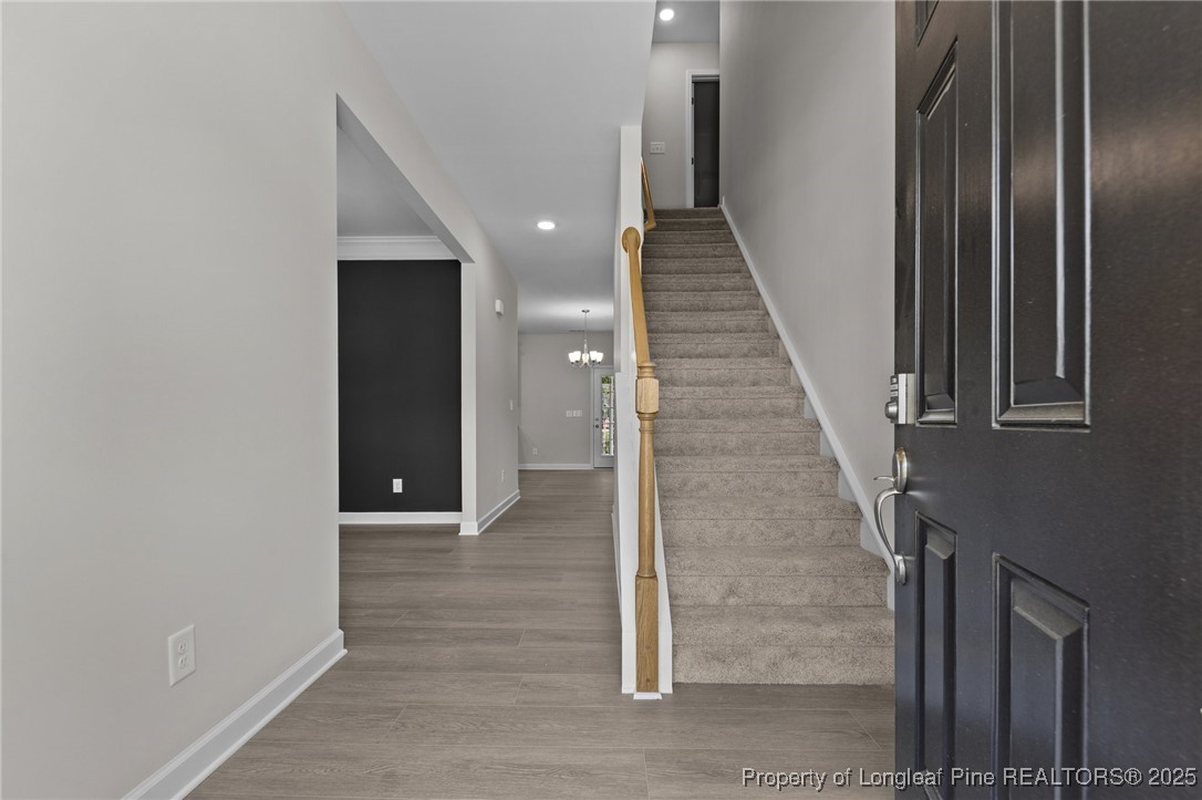 509 Watauga Lane Aberdeen, NC 28315 - Photo 4 of 29 a view of a hallway with wooden floor and staircase