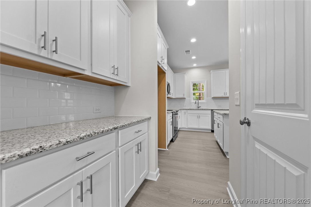 509 Watauga Lane Aberdeen, NC 28315 - Photo 7 of 29 a kitchen with white cabinets