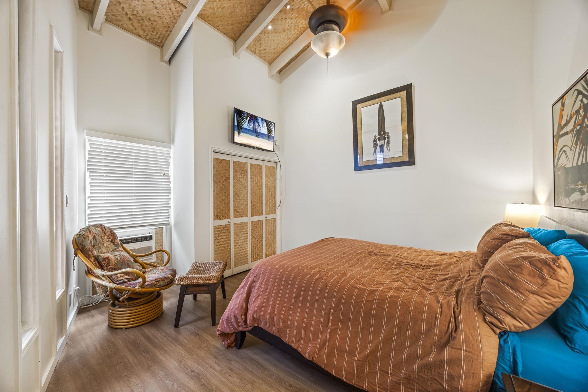 3959 Lower Honoapiilani Road, Unit A205 Lahaina, HI 96761 - Photo 14 of 36 a bedroom with a bed and wooden floor