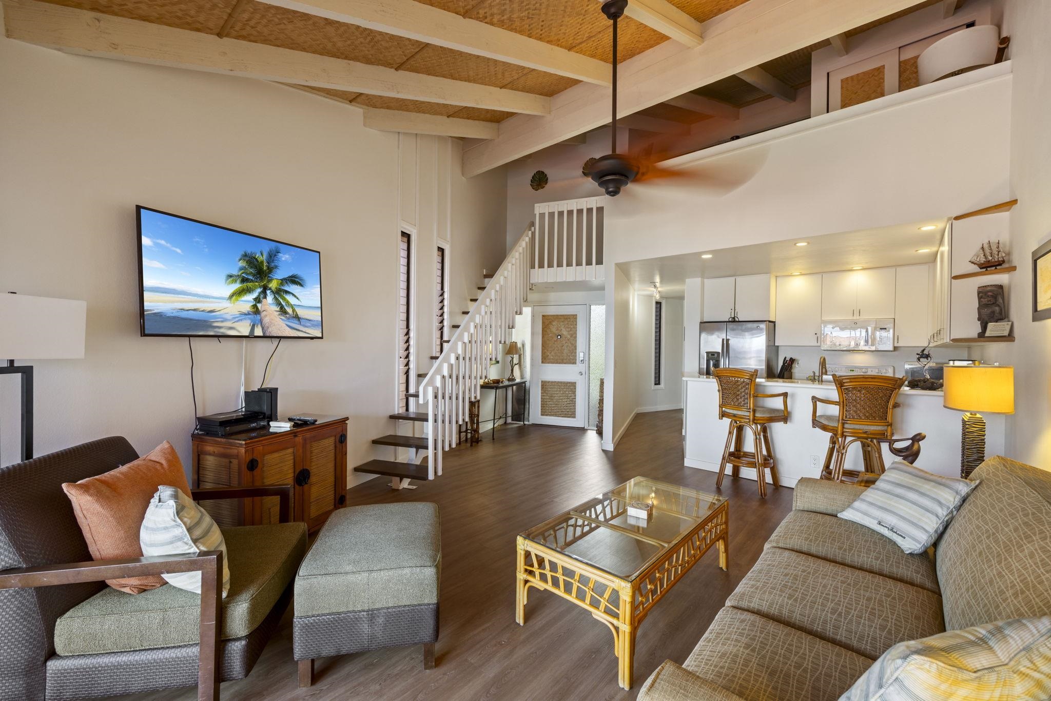 3959 Lower Honoapiilani Road, Unit A205 Lahaina, HI 96761 - Photo 6 of 36 a living room with furniture and a flat screen tv