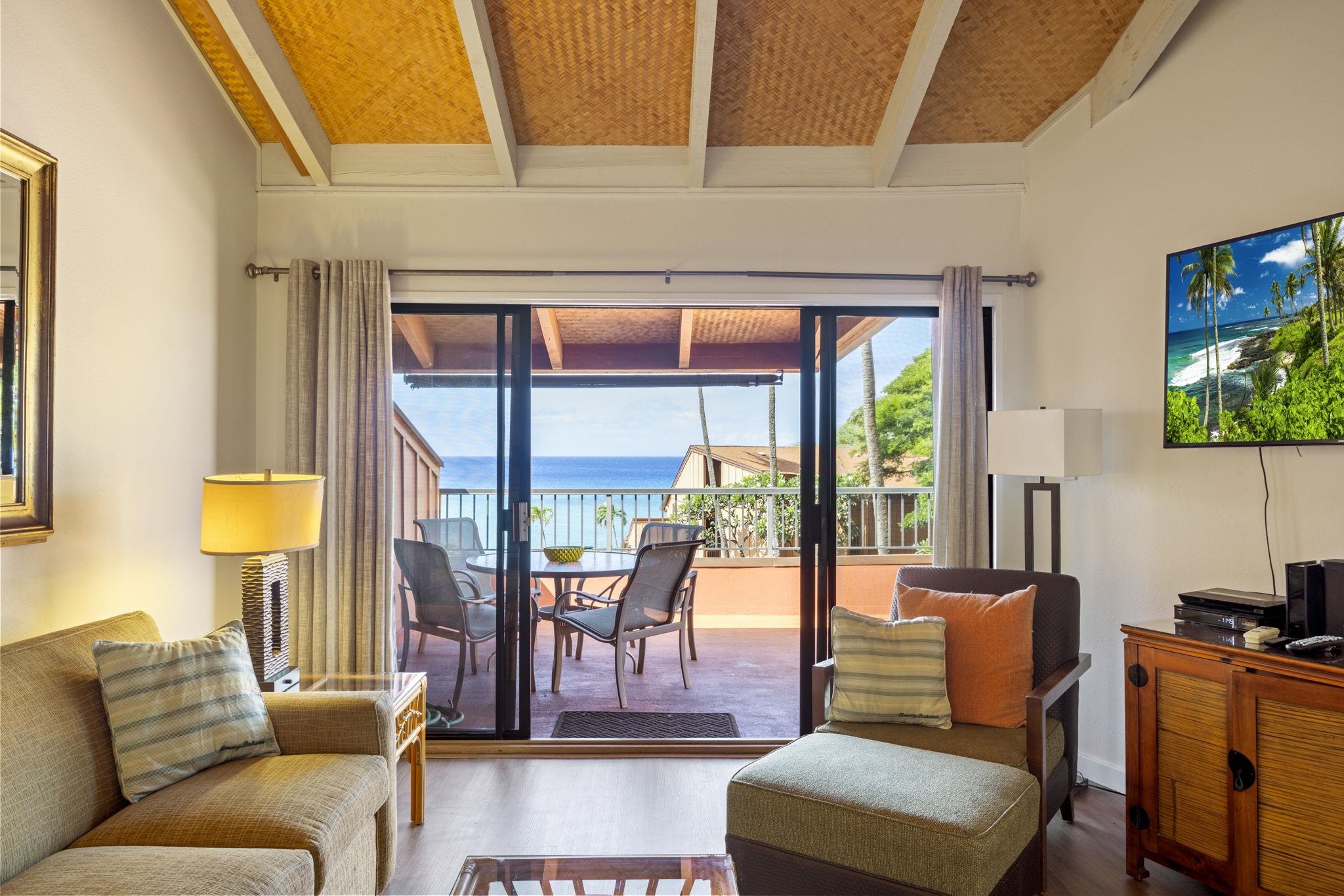 3959 Lower Honoapiilani Road, Unit A205 Lahaina, HI 96761 - Photo 8 of 36 a living room with furniture and a flat screen tv
