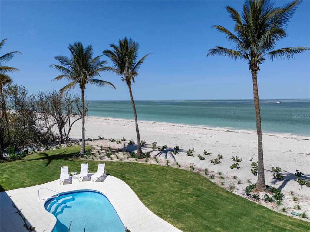 2979 Shore Lane Boca Grande, FL 33921 - Photo 11 of 57 a view of a swimming pool with a garden and patio