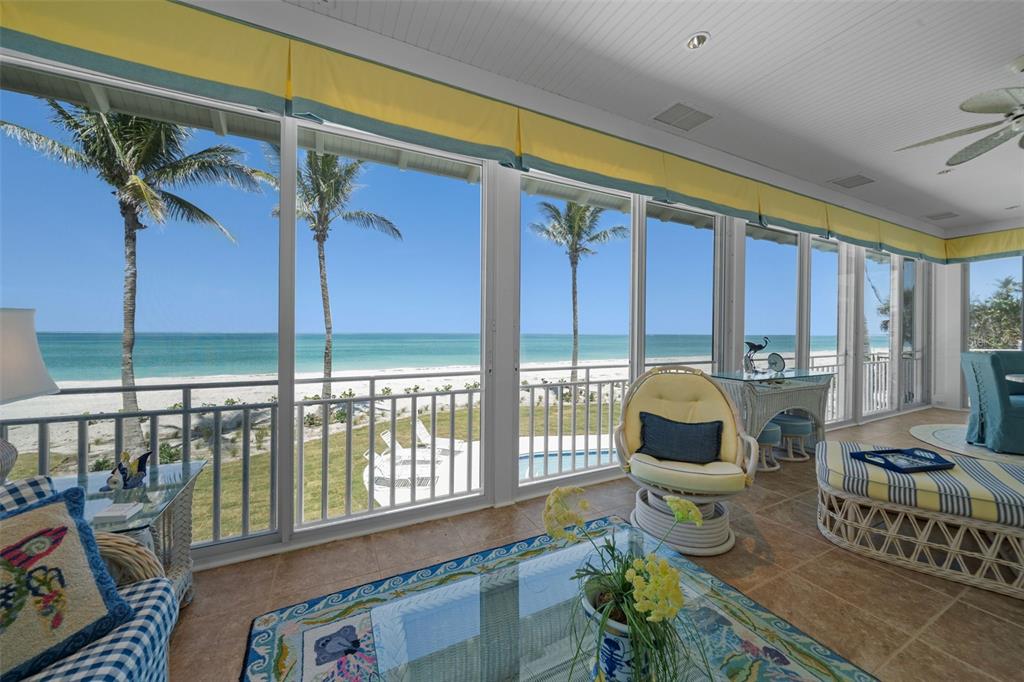 2979 Shore Lane Boca Grande, FL 33921 - Photo 22 of 57 a living room with furniture and a floor to ceiling window