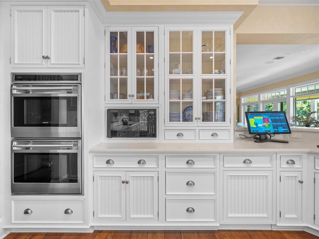 2979 Shore Lane Boca Grande, FL 33921 - Photo 29 of 57 a kitchen with white cabinets and stainless steel appliances