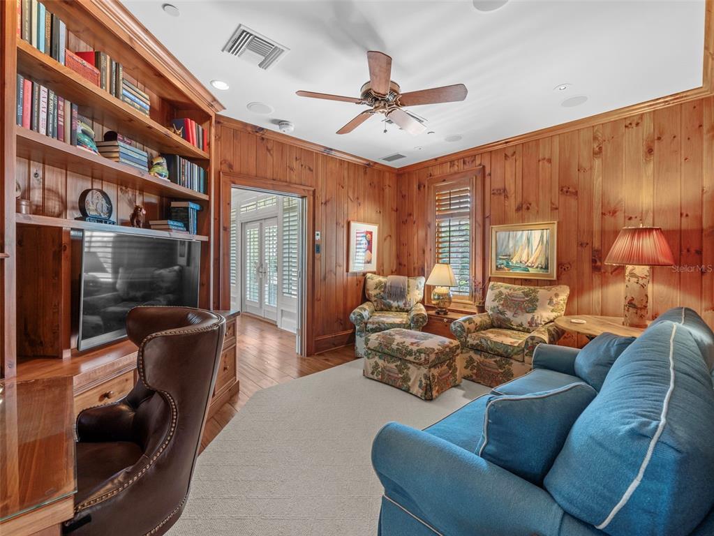 2979 Shore Lane Boca Grande, FL 33921 - Photo 33 of 57 a living room with furniture a bookshelf and a window