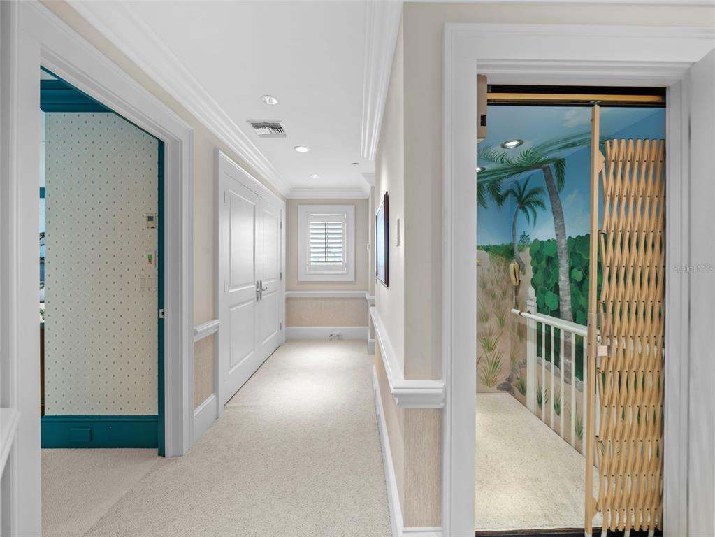 2979 Shore Lane Boca Grande, FL 33921 - Photo 44 of 57 a view of a hallway with wooden floor and windows