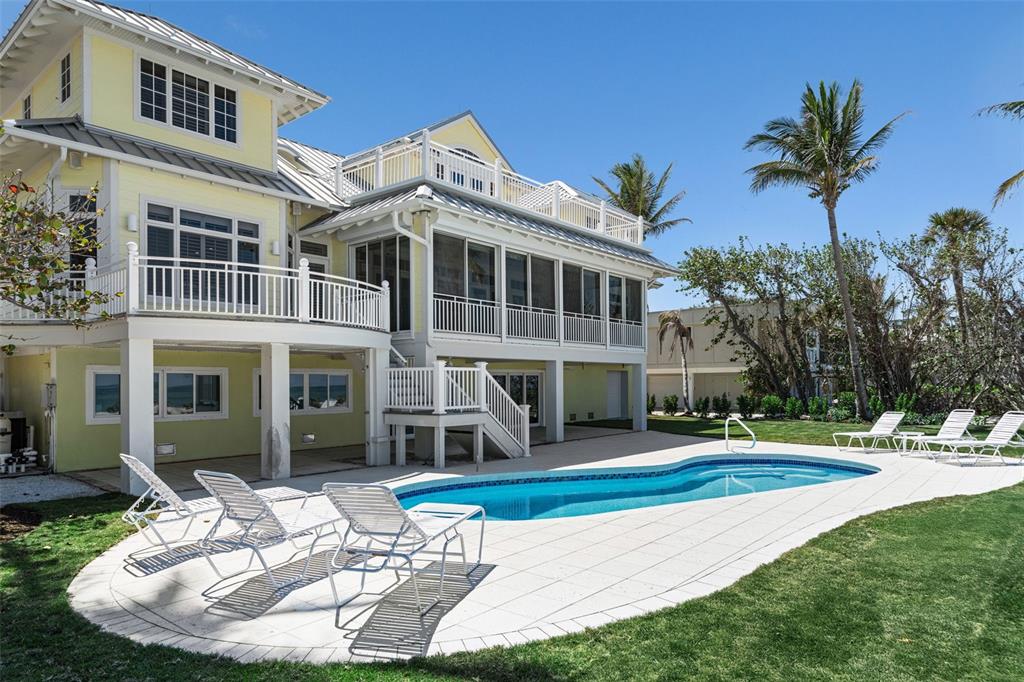 2979 Shore Lane Boca Grande, FL 33921 - Photo 10 of 57 a view of a white house with a yard table and chairs