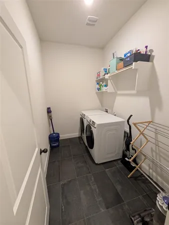 a bathroom with a tub a sink and a large mirror