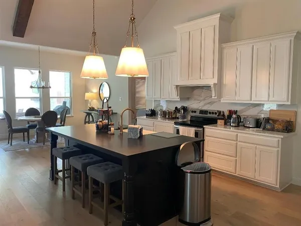 a view of a a dining room with furniture window and wooden floor