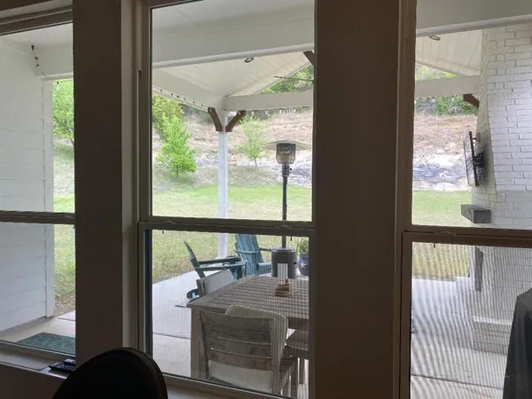 a kitchen with stainless steel appliances a table chairs refrigerator and cabinets