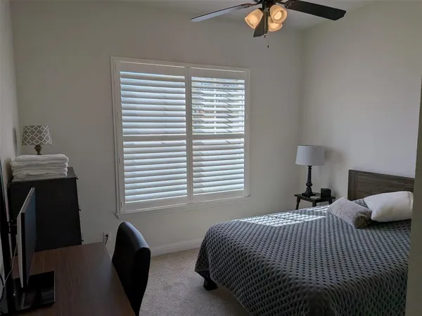 a view of hallway with a couch and chandelier
