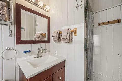 a bathroom with a sink vanity and a mirror