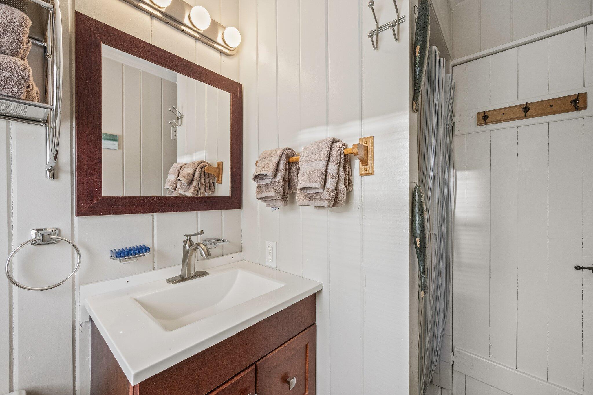 164 Kendrick Avenue, Unit C Wellfleet, MA 02667 - Photo 15 of 27 a bathroom with a sink vanity and a mirror