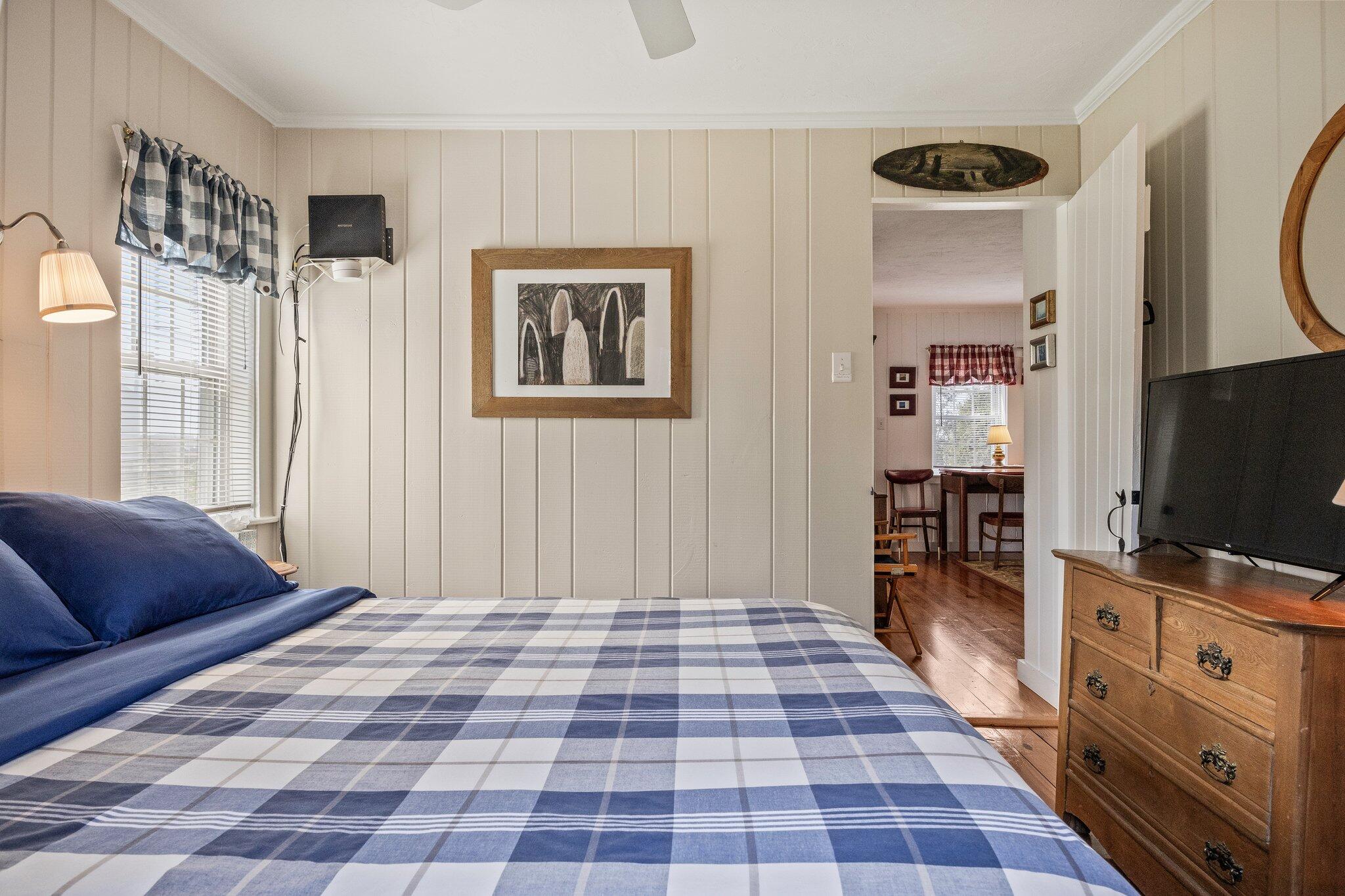 164 Kendrick Avenue, Unit C Wellfleet, MA 02667 - Photo 17 of 27 a bedroom with a bed and a flat tv screen on dresser