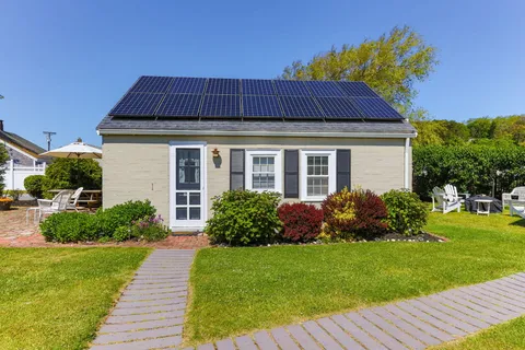 a front view of a house with a yard