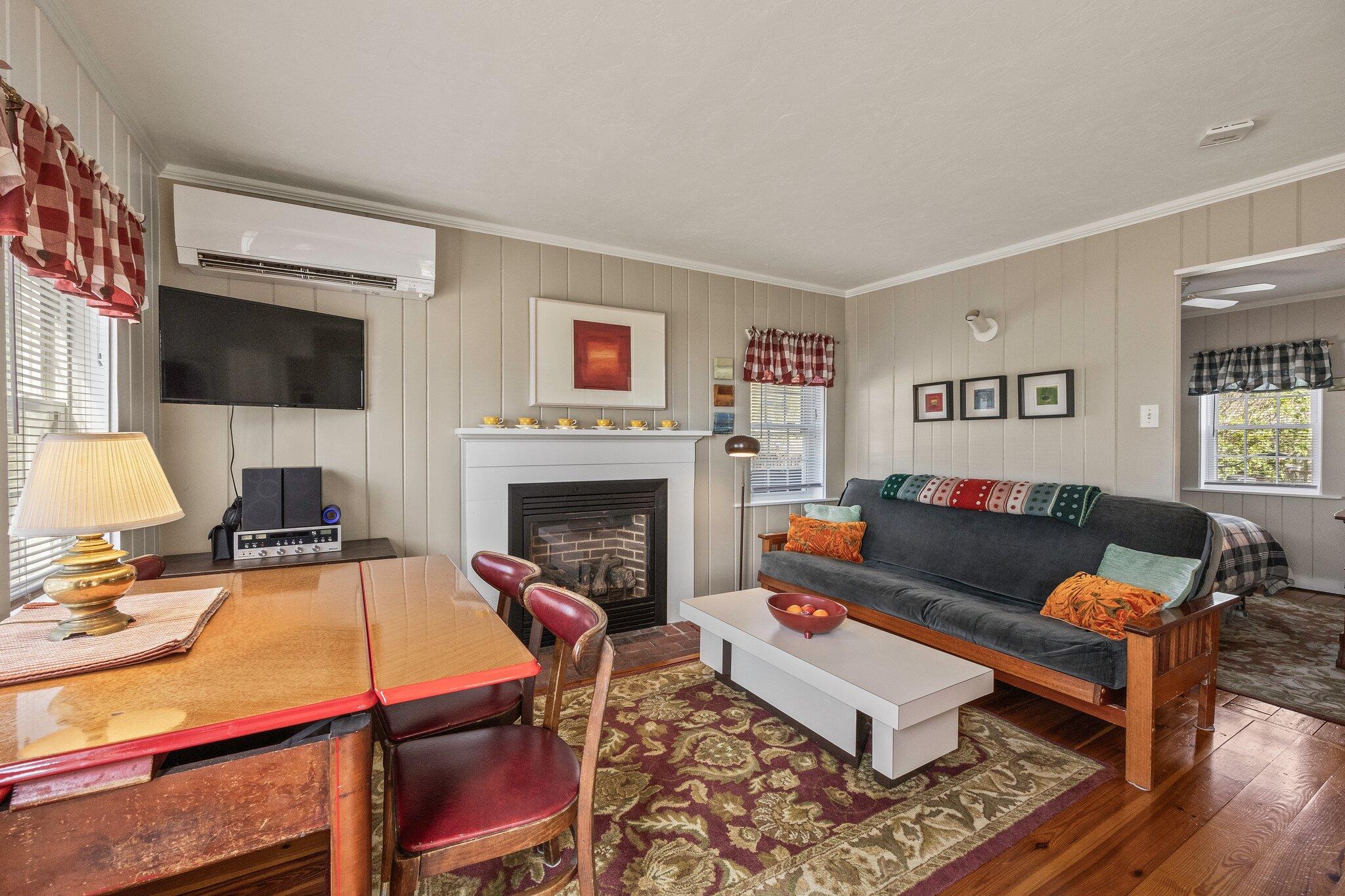164 Kendrick Avenue, Unit C Wellfleet, MA 02667 - Photo 7 of 27 a living room with furniture and a fireplace