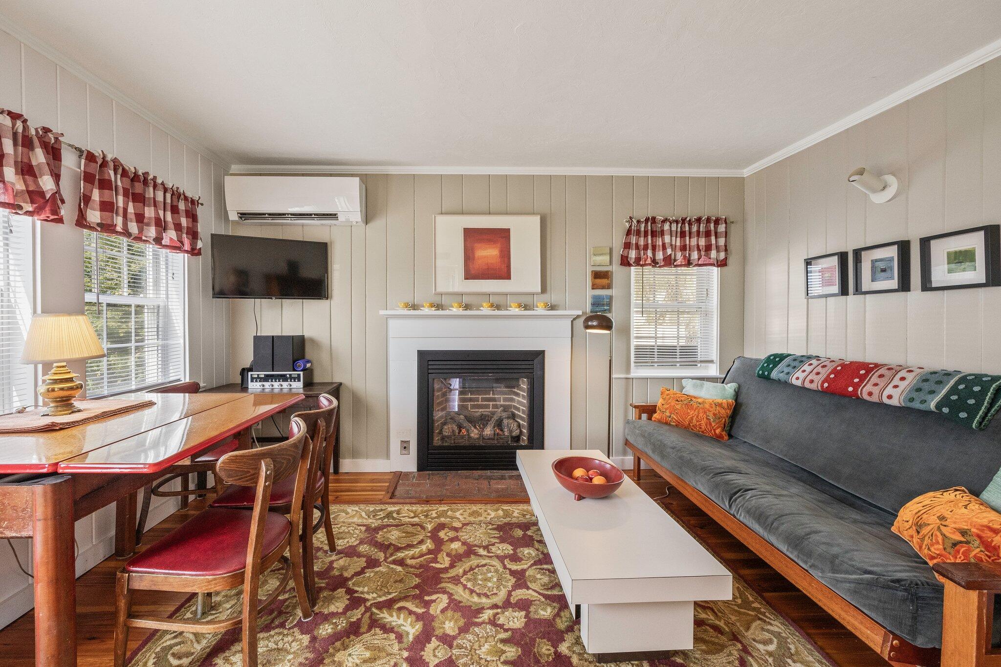 164 Kendrick Avenue, Unit C Wellfleet, MA 02667 - Photo 8 of 27 a living room with furniture and a fireplace