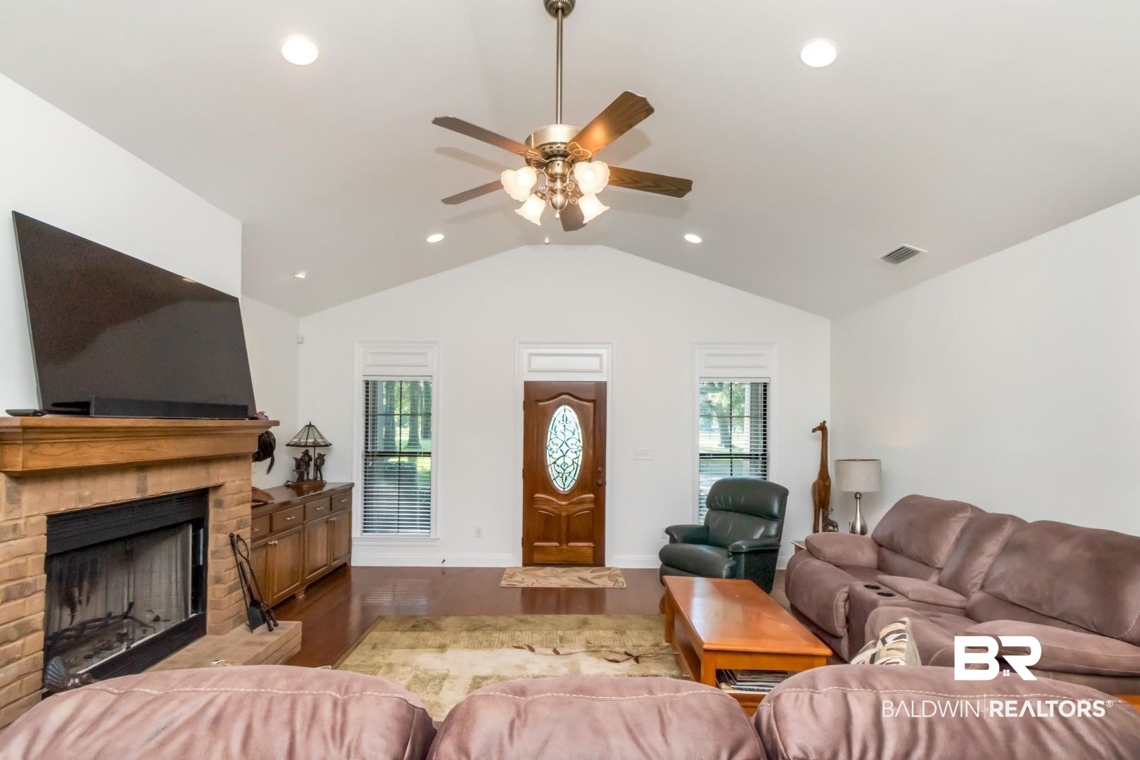 1360 Dykes Road North Mobile, AL 36608 - Photo 7 of 40 Living area featuring vaulted ceiling, a fireplace, wood finished floors, ceiling fan, and recessed lighting
