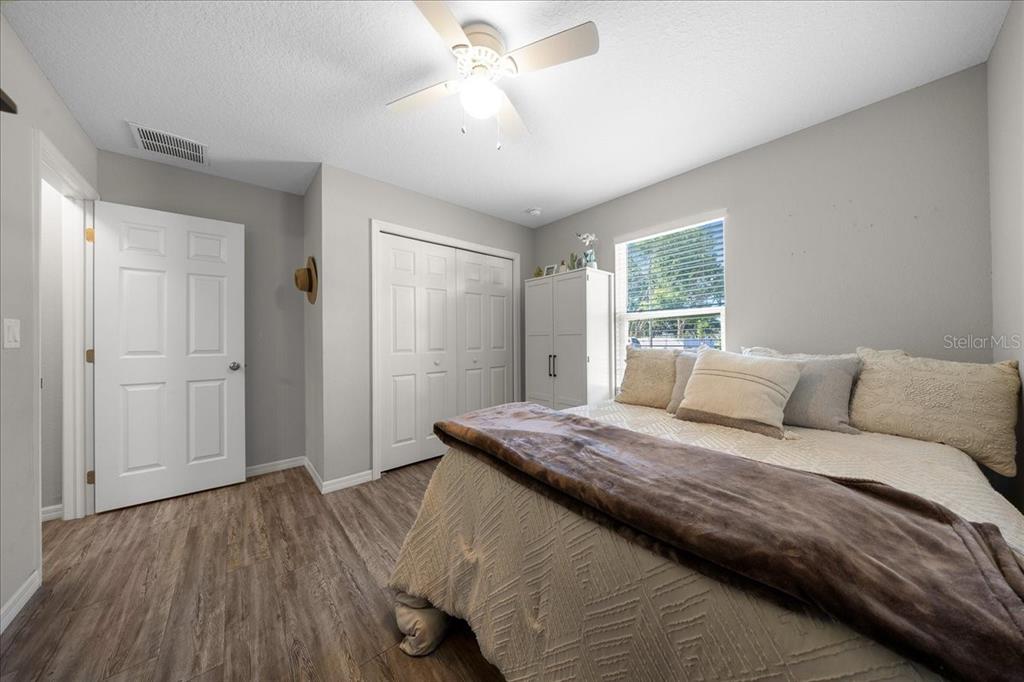 13 Teak Loop Place Ocala, FL 34472 - Photo 34 of 36 a bedroom with a bed and a chandelier