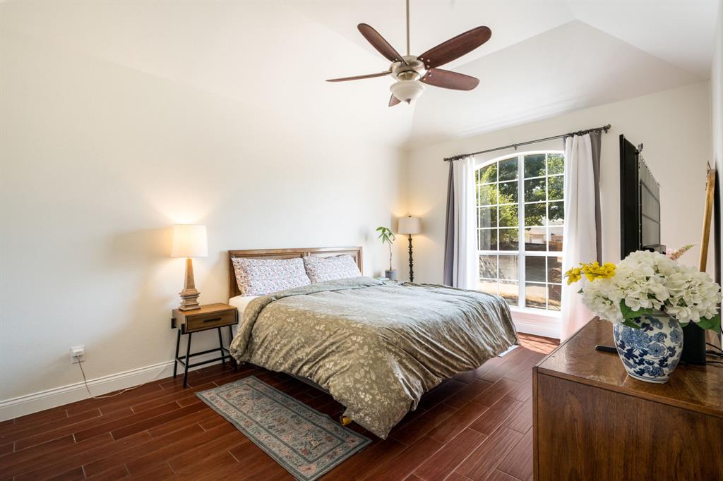 11414 Promenade Road Frisco, TX 75035 - Photo 5 of 24 Vaulted ceiling with a ceiling fan, arched window, wood-finish flooring, and light-toned walls