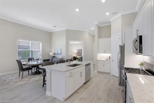 a kitchen that has a sink and a stove in it