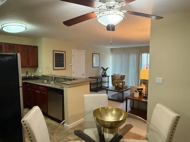 a kitchen with a refrigerator and a stove