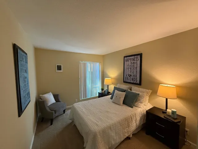 a bedroom with a bed and a lamp