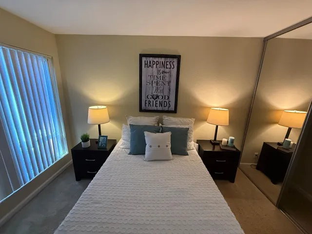 a bed room with a bed and a lamp