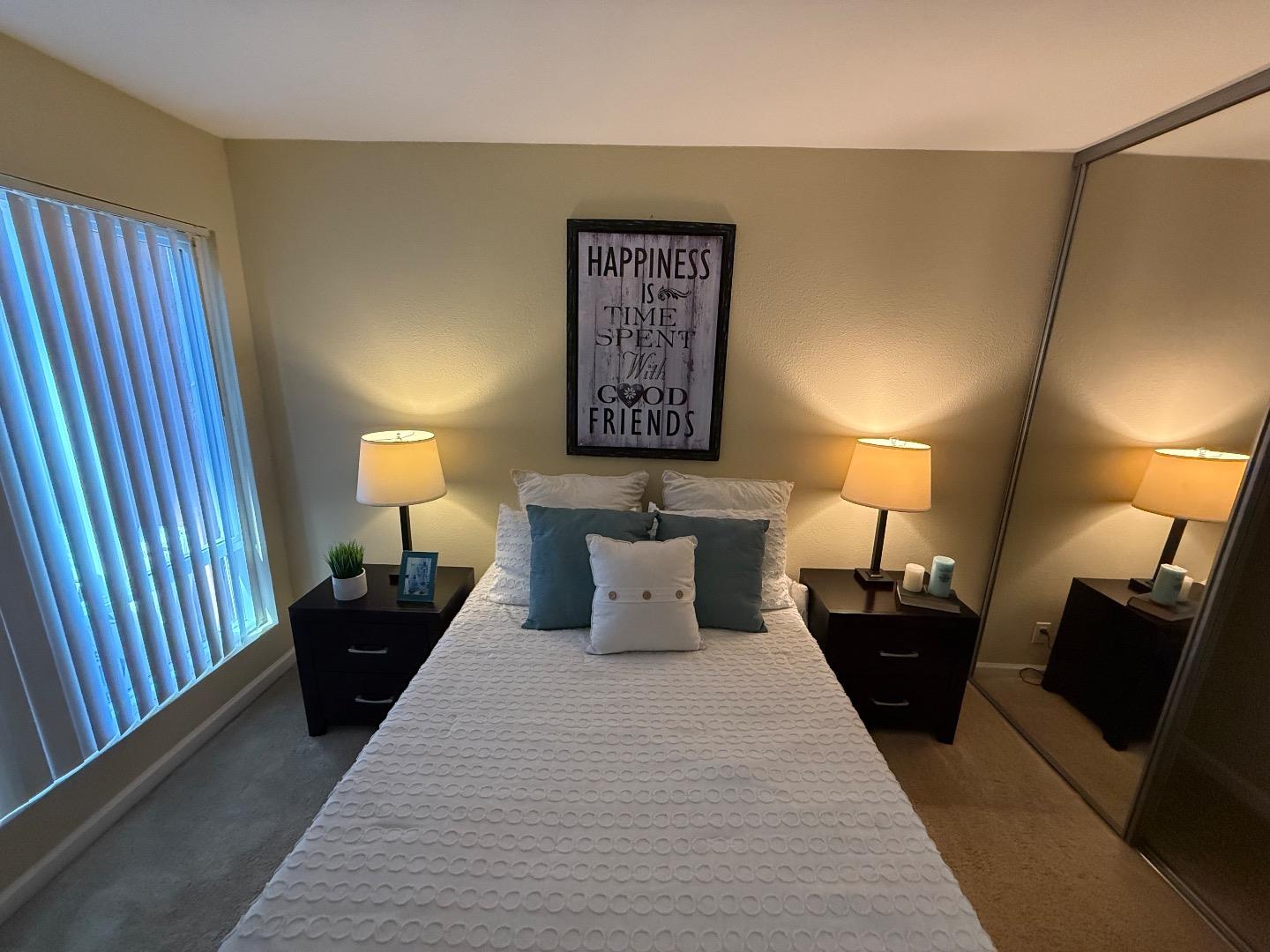 496 Dempsey Road, Unit 199 Milpitas, CA 95035 - Photo 17 of 41 a bed room with a bed and a lamp