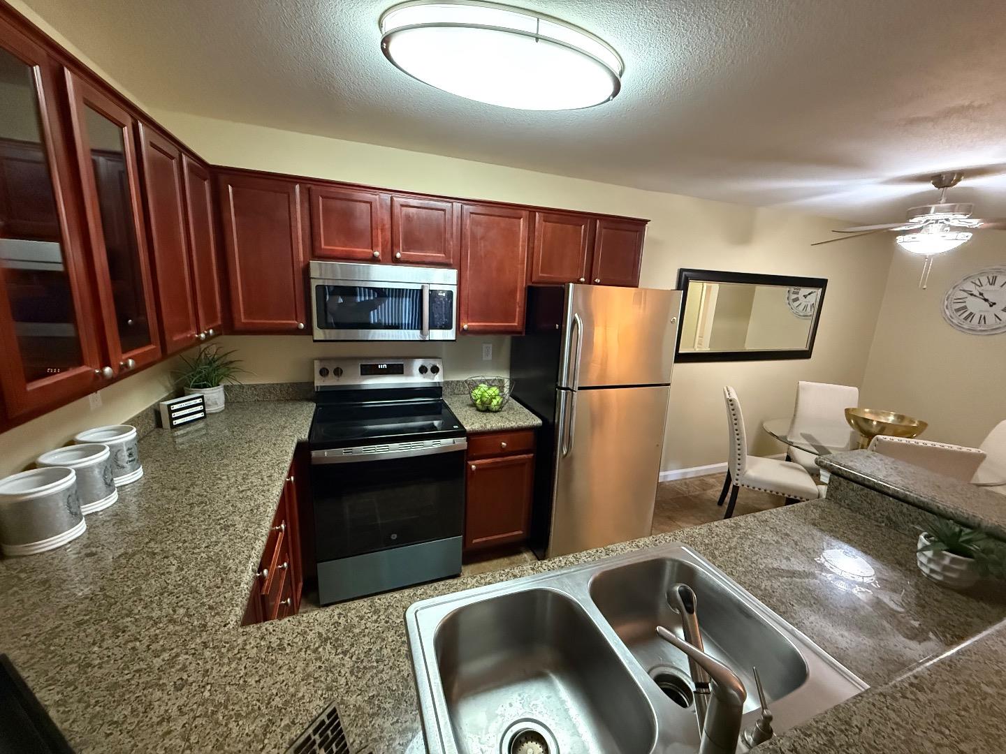 496 Dempsey Road, Unit 199 Milpitas, CA 95035 - Photo 2 of 41 a kitchen with a refrigerator sink and stove